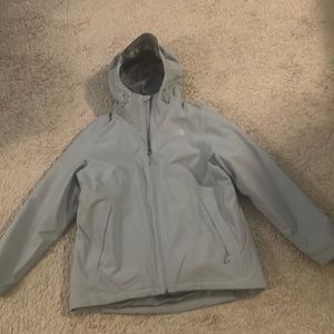 Gray North Face winter coat with a purple light jacket lining